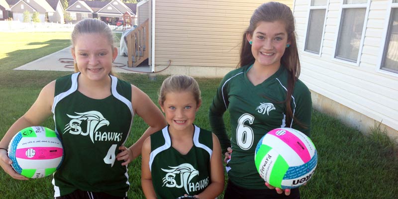 cheerleaders with pass it forward volleyballs